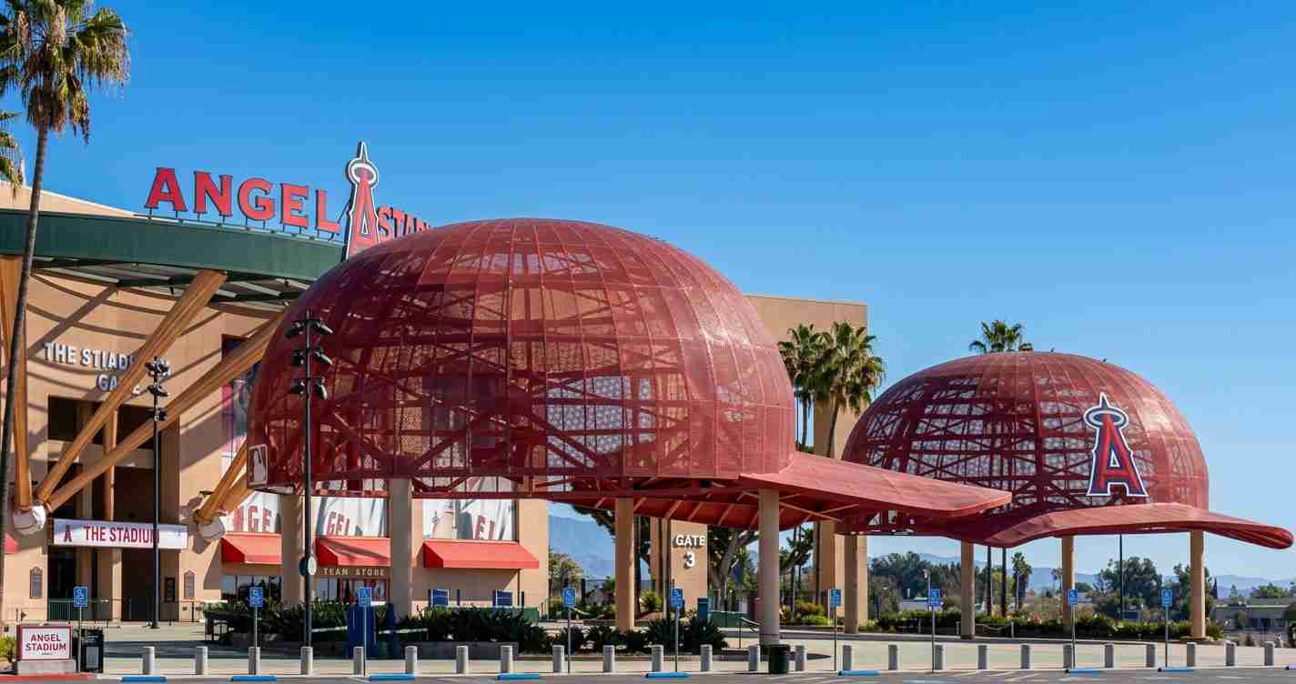 Angel Stadium of Anaheim exterior with two red lattice domes and clear blue sky in the background, signage visible on the building area? (informative)