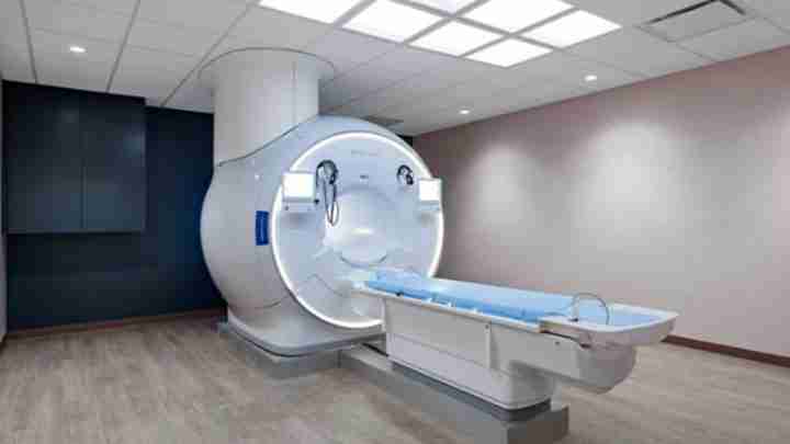 Large MRI scanner in a radiology room with a patient table ready for imaging